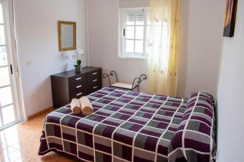 a bedroom with a bed with a checkered blanket at Tamaide Paradise C in Costa Del Silencio