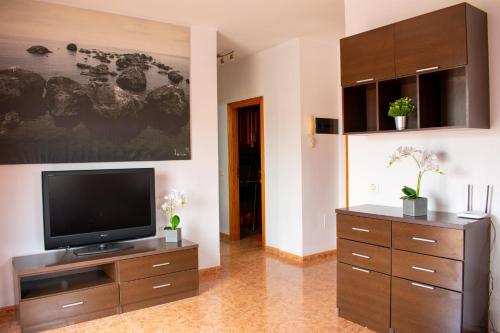 a living room with a television on a wooden entertainment center at Tamaide Paradise C in Costa Del Silencio