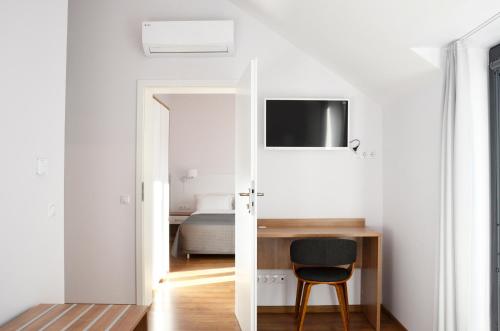 a room with a desk and a chair and a bed at Tip Tap Guest House in Druskininkai