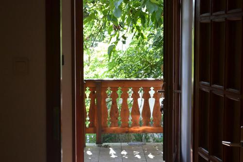 an open door to a balcony with a view at Erdőszéli Vendégház Zebegény in Zebegény