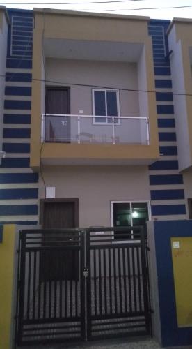 a house with a balcony with a railing at Maa Bhavan Homestay in Bharbharia