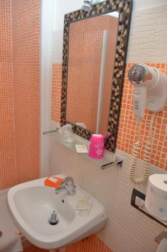 a bathroom with a sink and a mirror at Roma Gianicolense in Rome