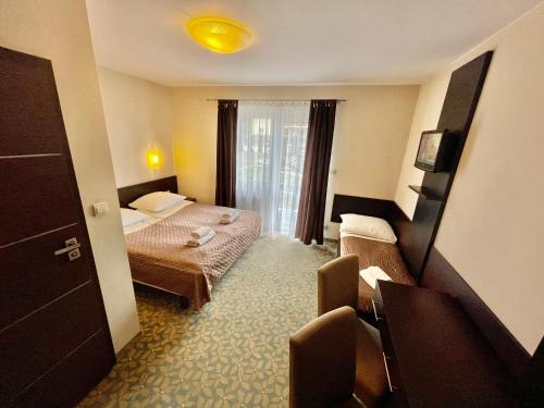 a hotel room with two beds and a window at Baltic Sun SPA in Rewal