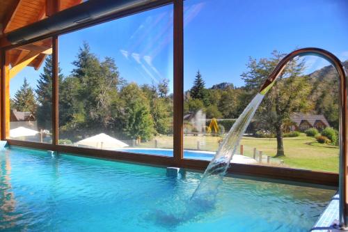 a water slide in a swimming pool at La Estancia Cabañas in Villa La Angostura