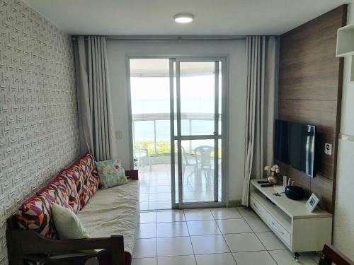 a living room with a couch and a television at Ap de Frente para o Mar de Itaparica II in Vila Velha