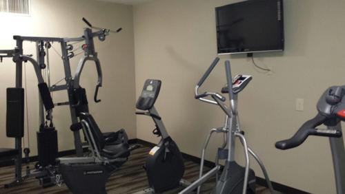 a room with several exercise bikes and a flat screen tv at Wingfield Inn in Mayfield