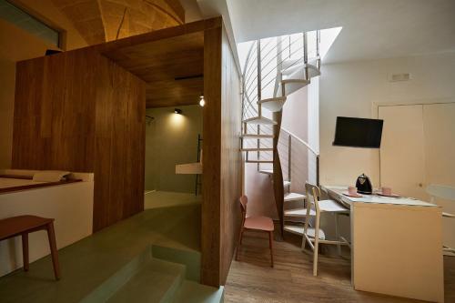 a room with a staircase and a desk with a computer at Liconti Exclusive Rooms in Pulsano