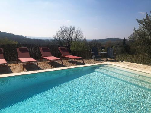 - une piscine avec des chaises longues et une table dans l'établissement Château Haut-Clarise, à Belvès-de-Castillon
