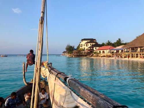 a group of people on a boat in the water at Atii Garden Bungalows in Nungwi