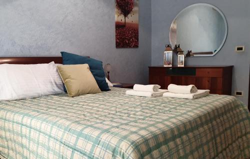 a bedroom with a bed with two towels on it at Le Marille in Lido di Ostia