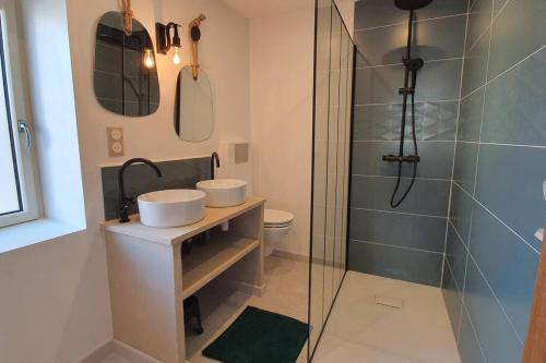 a bathroom with two sinks and a shower at PETIT COCON in Boisset-Saint-Priest