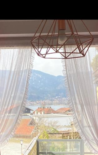 a window with white curtains and a view at Zentral am See in Tegernsee in Tegernsee