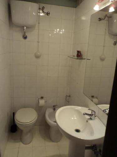 a white bathroom with a toilet and a sink at LA MANSARDA in Cerreto Guidi