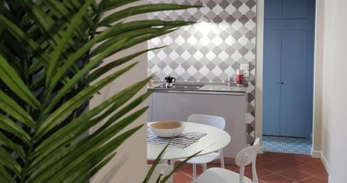 a kitchen with a table and chairs and a sink at LaMalatestina Suite - Apartment in front of the Castle in Rimini