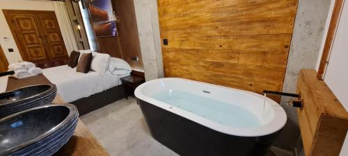 a bathroom with two sinks and a bath tub at Murallas de Jayrán Hotel Boutique in Almería
