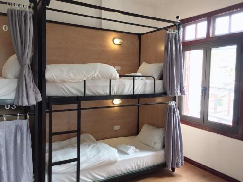 two bunk beds in a room with a window at An Homestay - Bar & Motorbike Rental in Cao Bằng