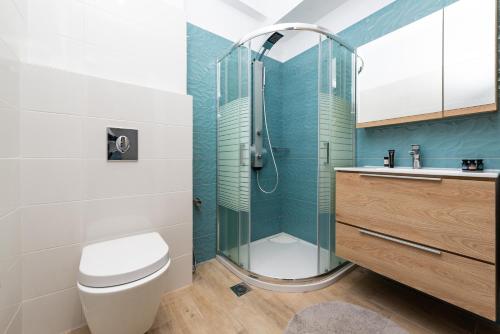 a bathroom with a shower and a toilet and a sink at Ritas Modern In-City House in Rhodes Town