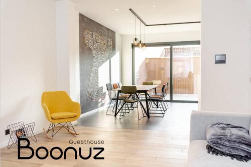 a living room with a dining room table and chairs at Boonuz guesthouse, luxe duplex vakantiehuis in centrum Ieper met privé lounge terras en IR sauna in Ypres