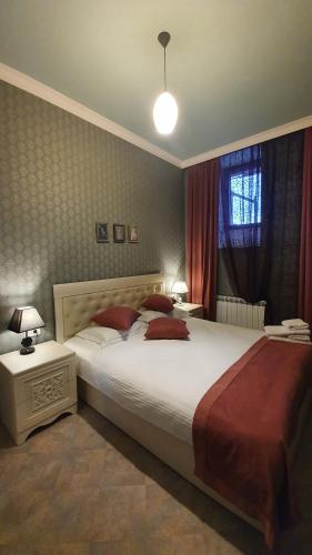 a bedroom with a large white bed and a window at JINJOTEL Gyumri in Gyumri