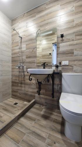 a bathroom with a sink and a toilet and a shower at JINJOTEL Gyumri in Gyumri