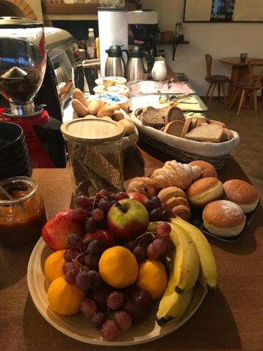a table topped with plates of fruit and other foods at Penzion Pod Radnicí in Hustopeče
