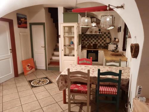 a kitchen with a table and chairs in a room at Appartamento Sopramonte in Trento