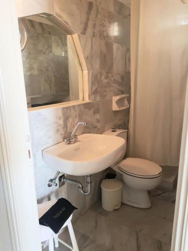 a bathroom with a sink and a toilet at 4BD Blue Dream Mykonos in Mikonos