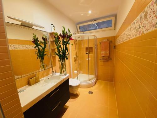 a bathroom with a sink and a shower and a toilet at Apartment AlMare in Opatija