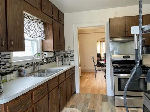 a kitchen with a sink and a stove top oven at 2 BR Apt near Great Lakes Naval Base and 6 Flags in Waukegan
