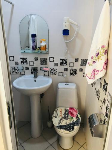 a small bathroom with a sink and a toilet at PAPILLON in Chakvi