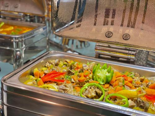 a tray of food with peppers and vegetables at Violet Al Shisha Hotel in Makkah
