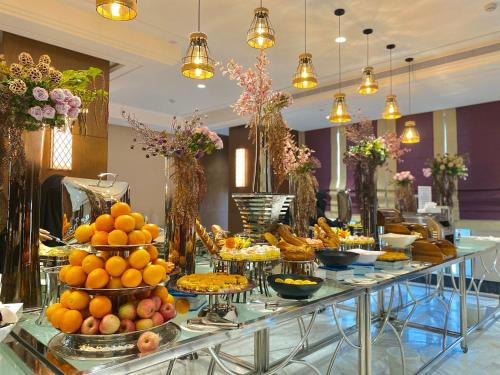 a buffet of food on a table in a hotel at Violet Al Shisha Hotel in Makkah