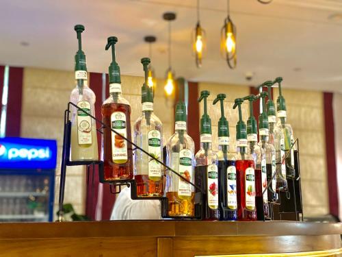a group of bottles of alcohol on a bar at Violet Al Shisha Hotel in Makkah