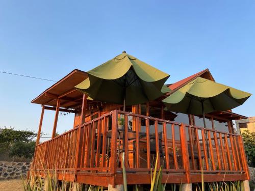 a wooden stand with umbrellas on top of it at Villarreal Lodge Hotel Ecológico in Totolapan