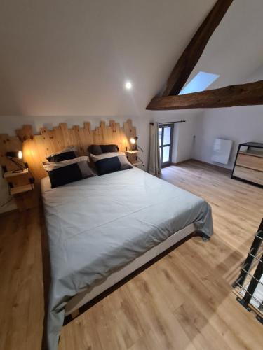 une chambre avec un grand lit et un parquet dans l'établissement Les Logis du rempart, à Loches