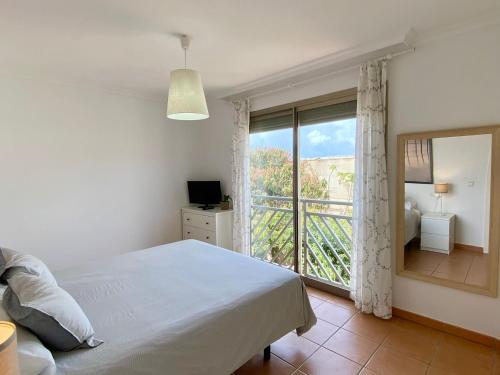 a bedroom with a bed and a large window at Apartamento en Playa de la Tejita, El Medano in Granadilla de Abona