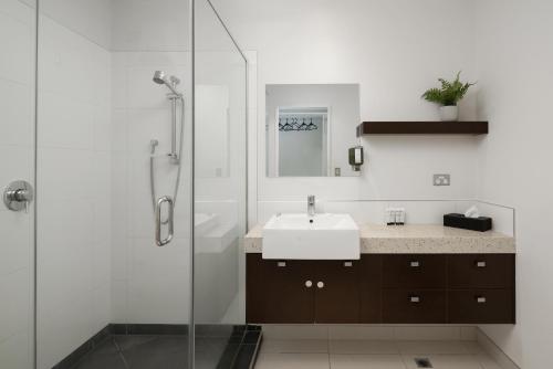a bathroom with a sink and a shower at Luxury Waterfront Apartment - Abode No 1 in Picton