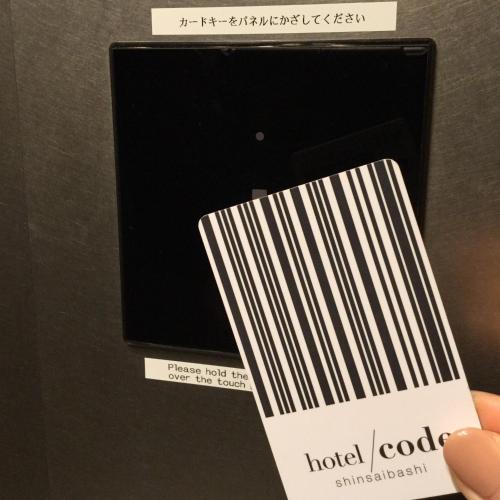 a person holding a cell phone with a label on it at Hotel Code Shinsaibashi in Osaka