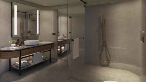 a bathroom with a glass shower and a sink at Crystalbrook Kingsley in Newcastle