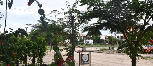 a park with trees and a sign on a dirt road at Casa Liria Gael - Kite Is Surf School in Jericoacoara