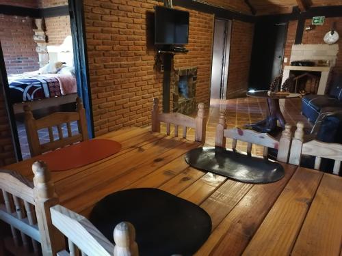 a room with a wooden floor and a fireplace at Cabanas Sierra Nublada in Chignahuapan
