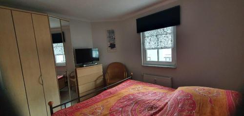 キュールングスボルンにあるHaus-Atlantik-Wohnung-3-19-652のベッドルーム(ベッド1台、テレビ、窓付)