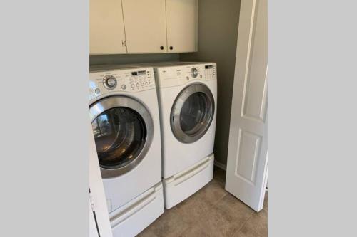 a white washer and dryer in a laundry room at Home On the Green in Salado