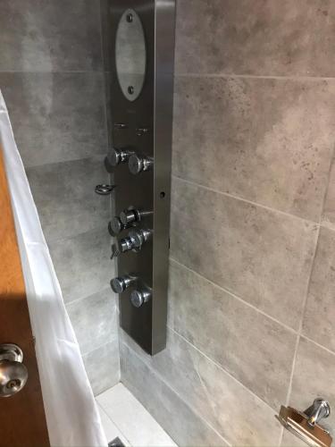 a bathroom with a shower stall with a mirror at Lo de Joaco y Marti in Punta Del Diablo
