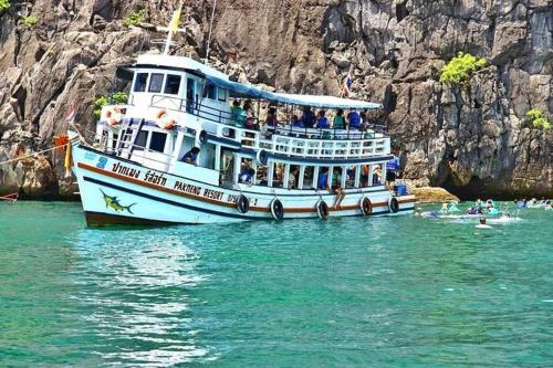 a boat in the water with people on it at Pakmeng Resort in Pak Meng