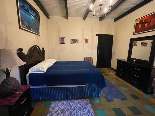 a bedroom with a bed and a television in it at Villas JABEL TINAMIT in Panajachel