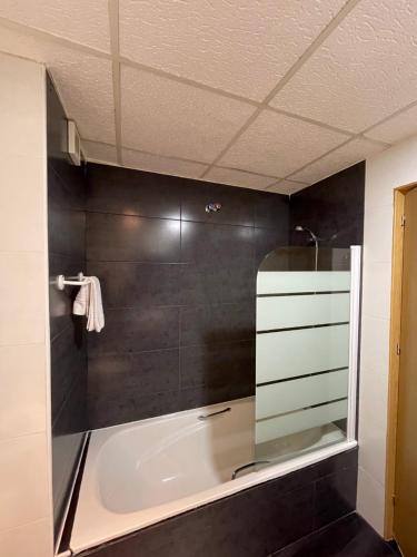 a bathroom with a bath tub and a shower at Condedu in Badajoz