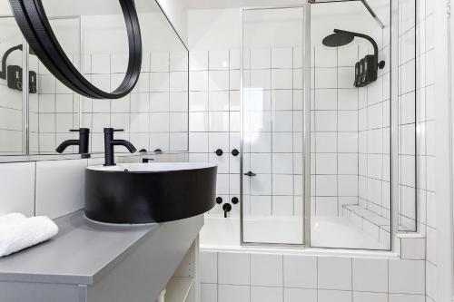 a bathroom with a sink and a shower at Davis Avenue Apartments in Melbourne