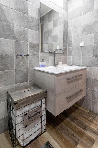 a bathroom with a sink and a mirror at Villa Dimitrios in Kiotari