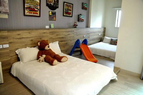 a bedroom with a teddy bear sitting on a bed at D3 Classic BNB in Wujie